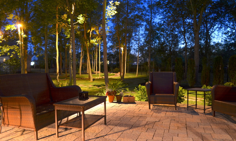 Backyard patio with chairs and outdoor lighting